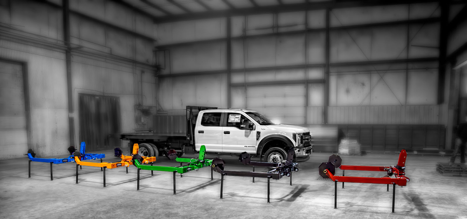 All five colors of the 3 Point Round Hay Bale Unroller displayed in the Parkhurst facility